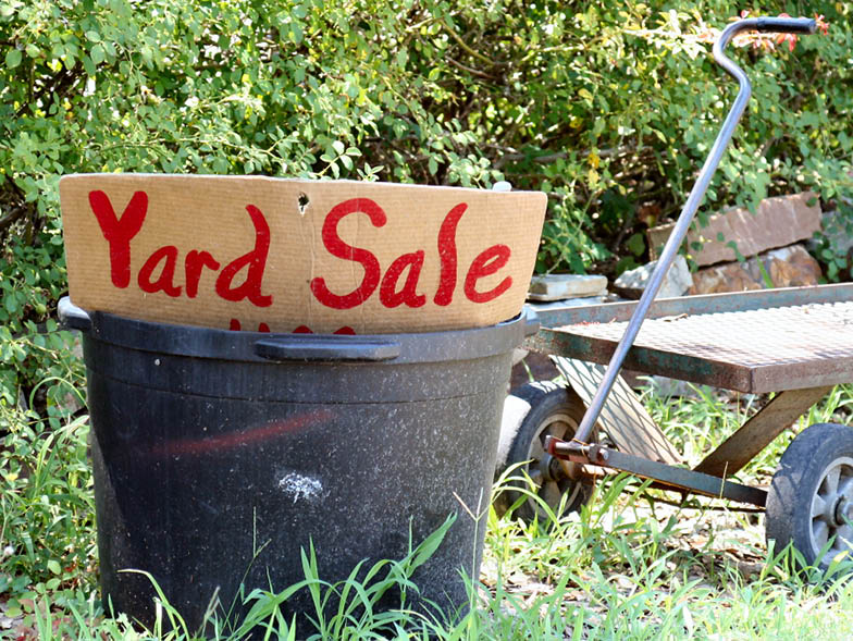 Hand painted yard sale sign in bucket