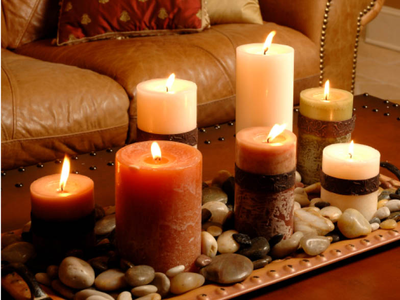 Candles in various sizes lit on coffee table