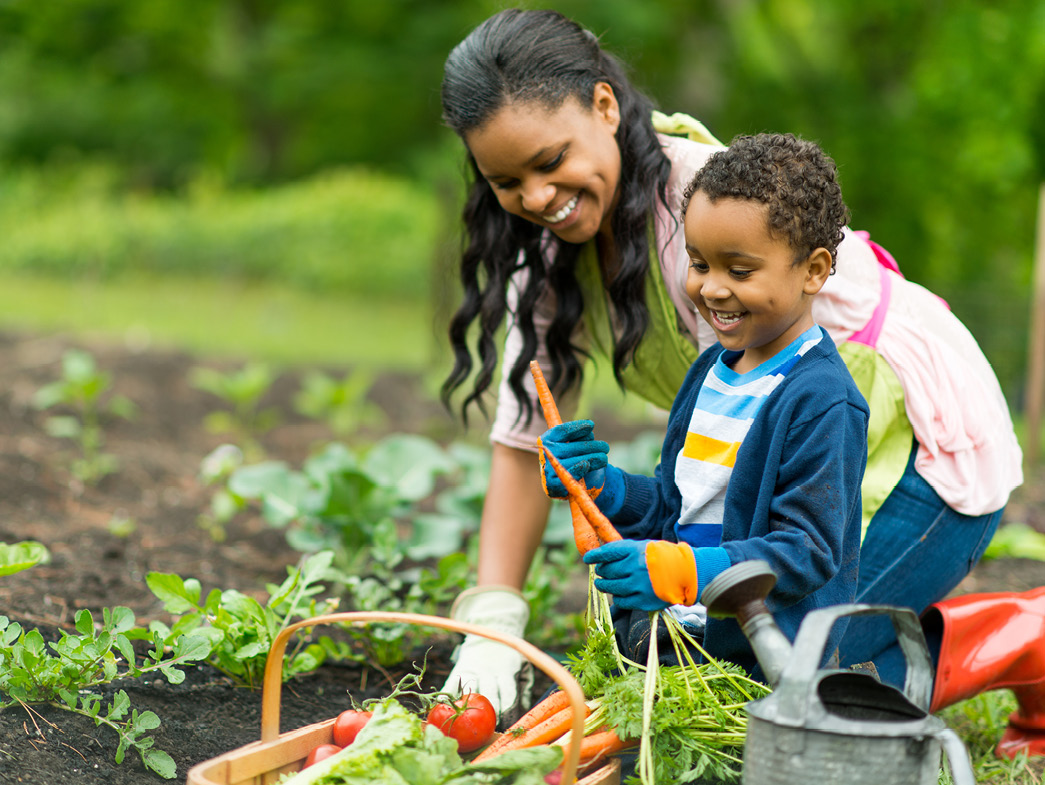 Woman and son gardening