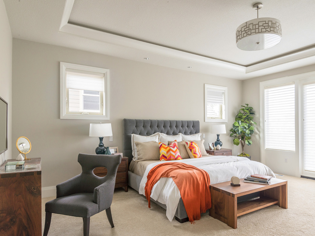 Gray and white bedroom with orange accents