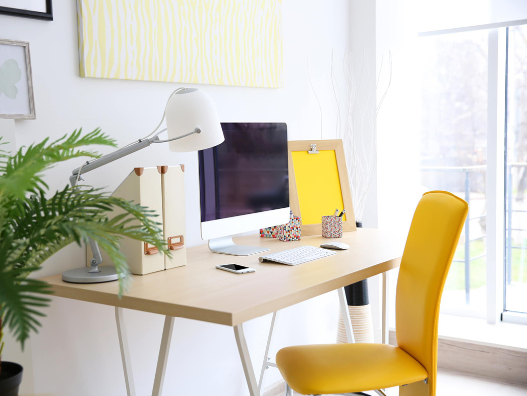 Desk with computer and yellow chair