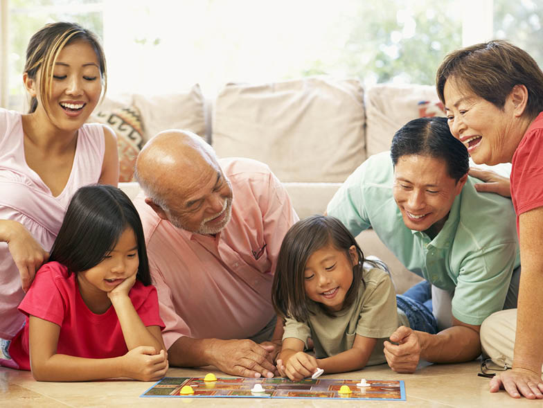Family playing board game on living room floor