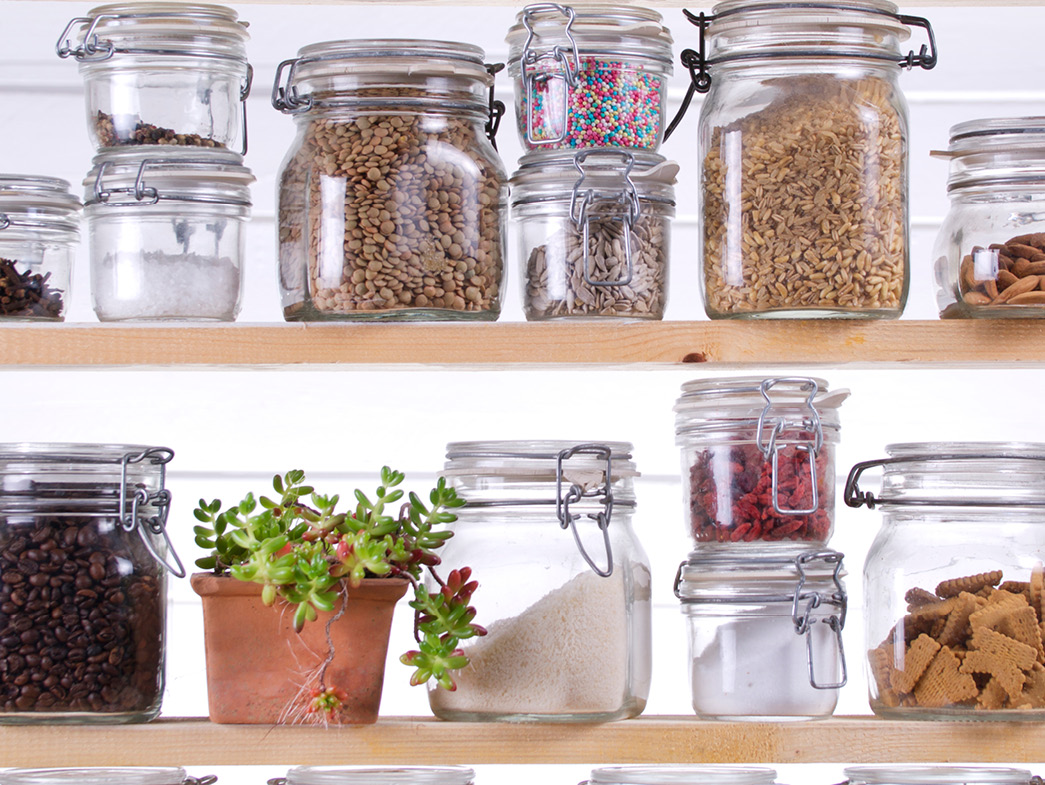 Food stored in glass jars on shelves
