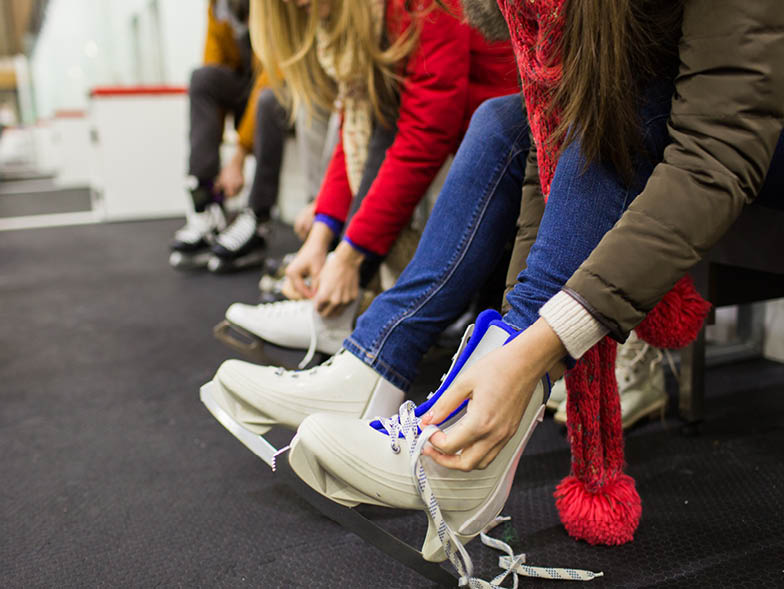 Person tying ice skate lace