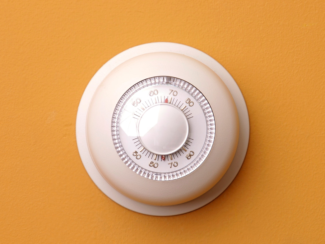 Thermostat on yellow wall
