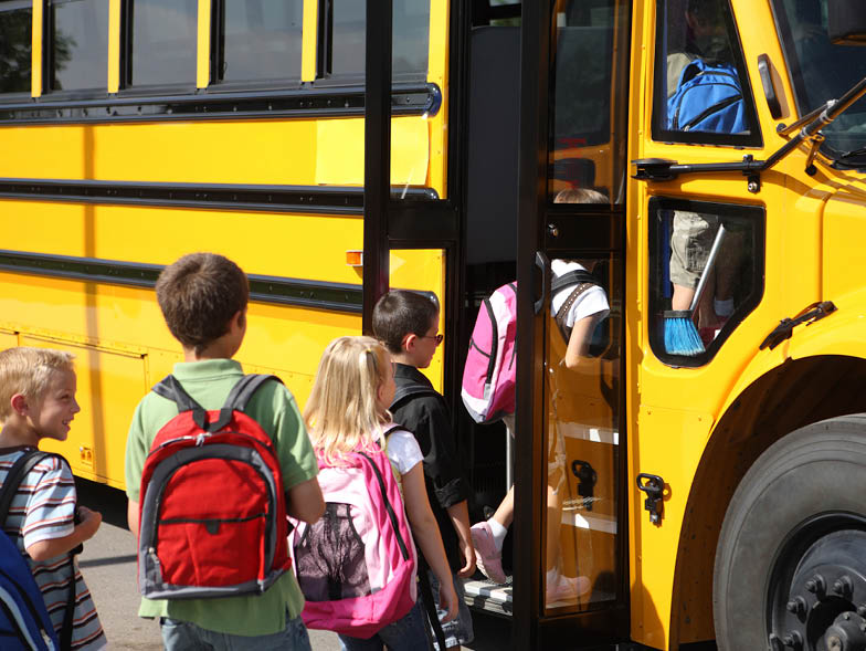 Children getting on a school bus