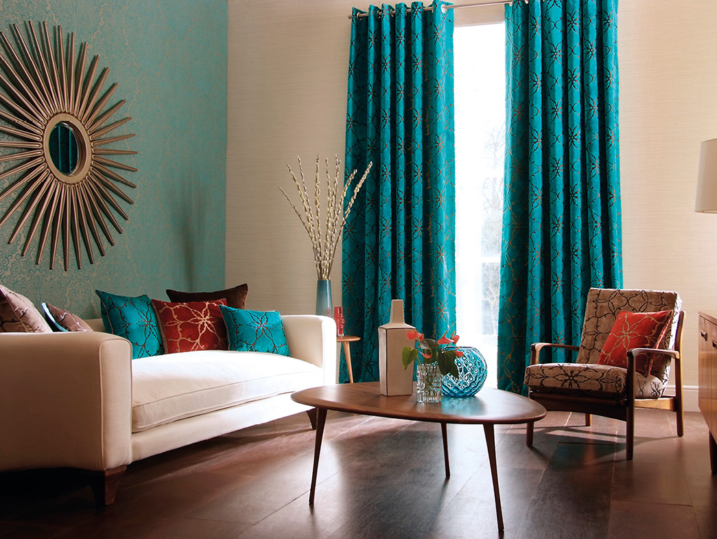 Living room with blue accent wall and blue curtains