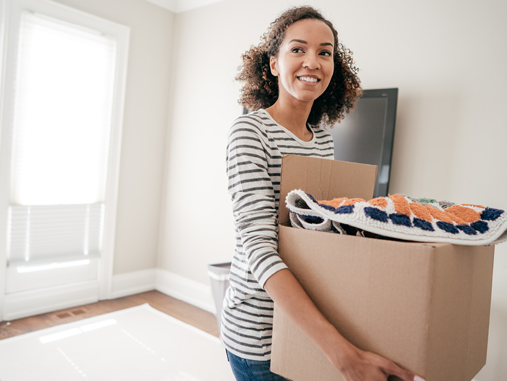 Woman taking out box of clutter