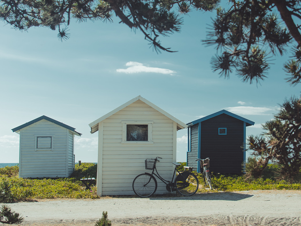 3 tiny houses with bicycle in front