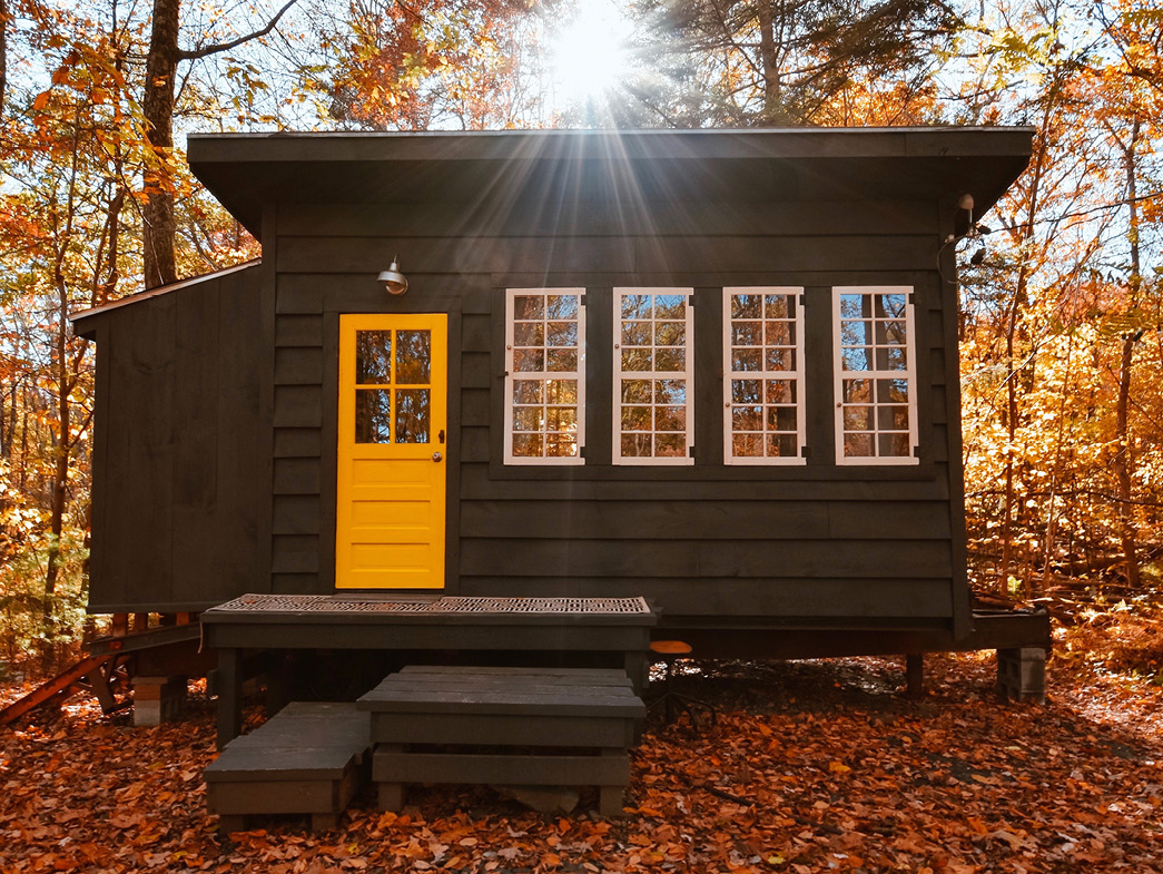 Brown tiny house with yellow door