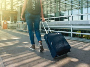 Woman pulling luggage at airport