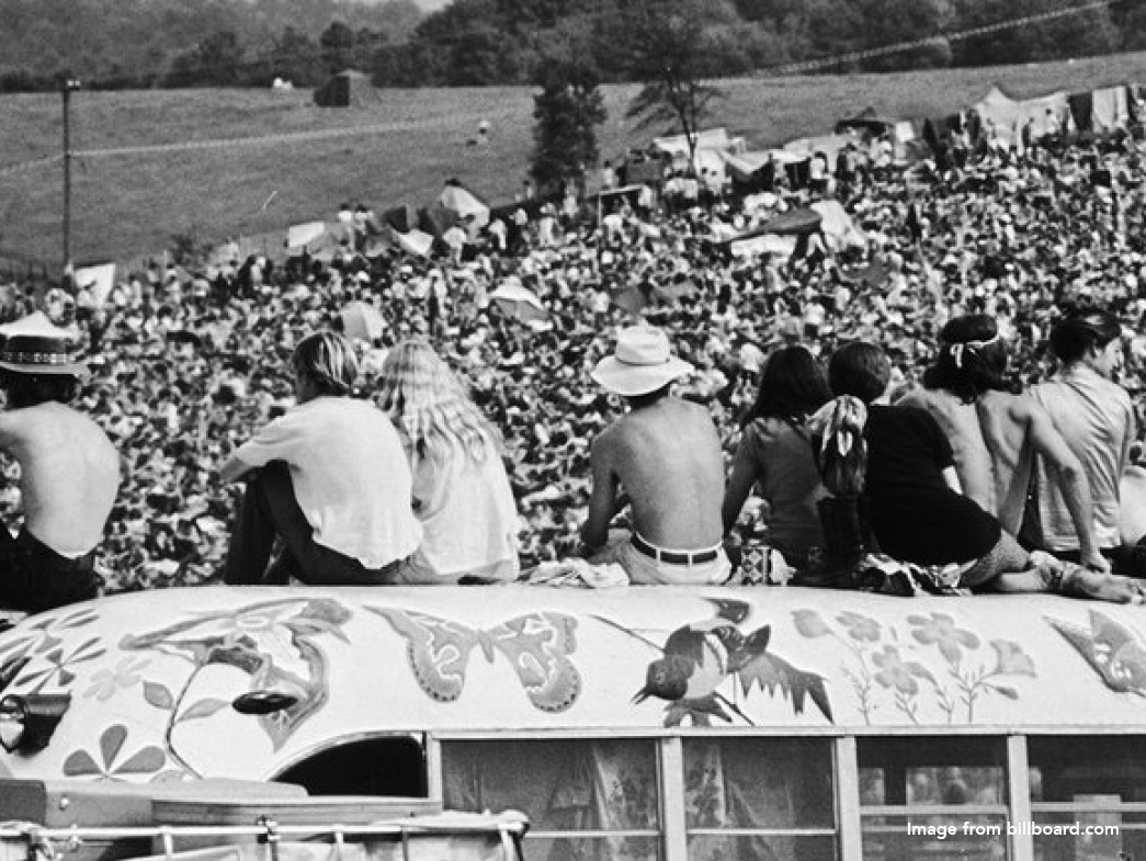People sitting on decorated bus at Woodstock