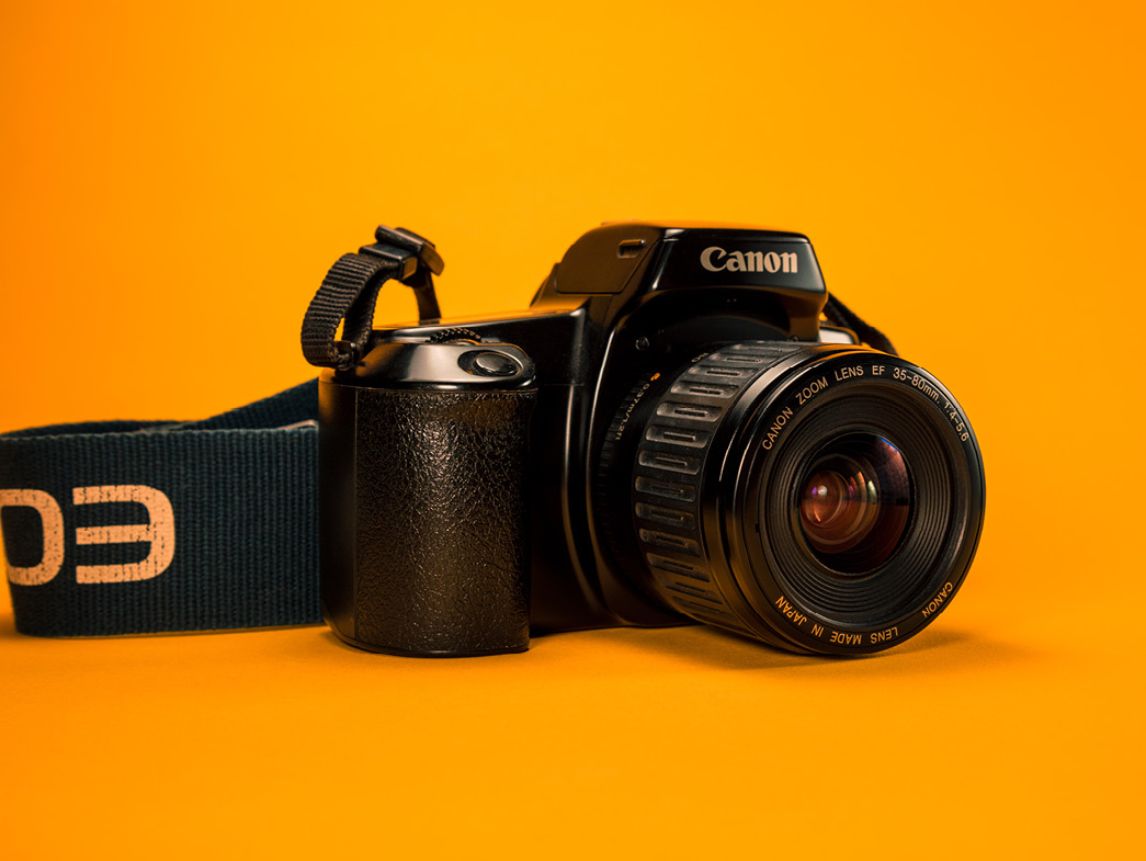 Professional camera on orange background