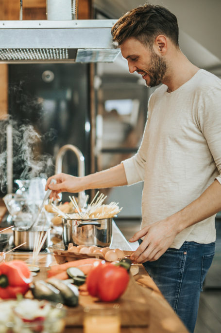 man cooking meal in kitchen