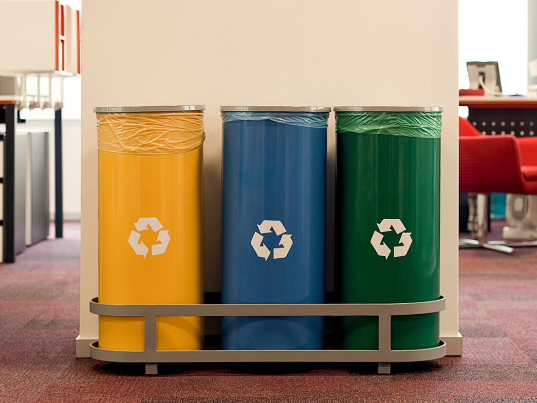 Three cans featuring the recycling symbol