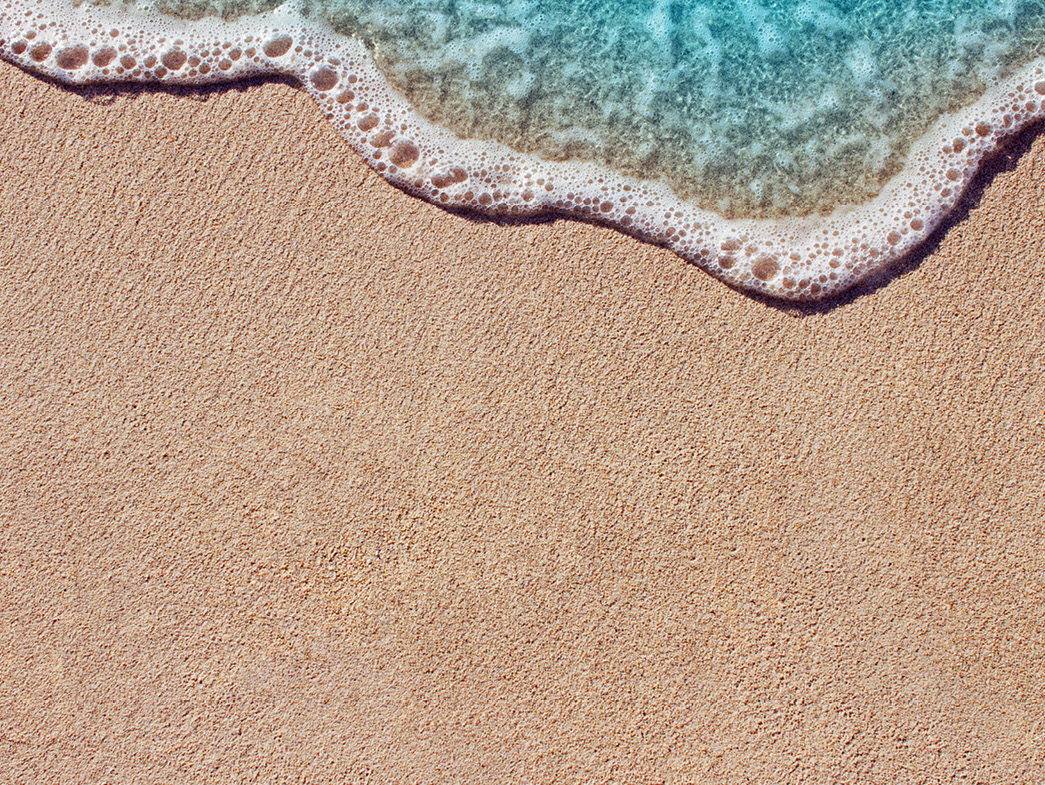 Blue water lapping at sand