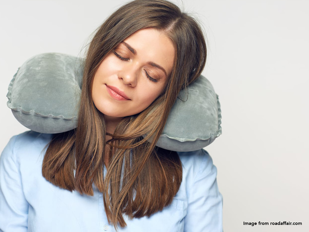 Woman wearing neck pillow for travel