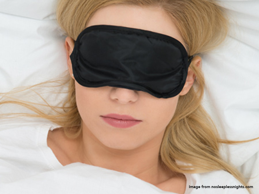 Woman sleeping with black eye mask on