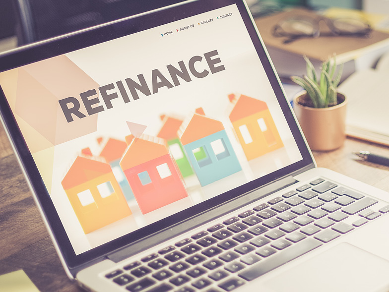laptop with houses and refinance