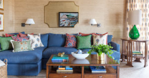 tan living room with blue sofa and colorful pillows