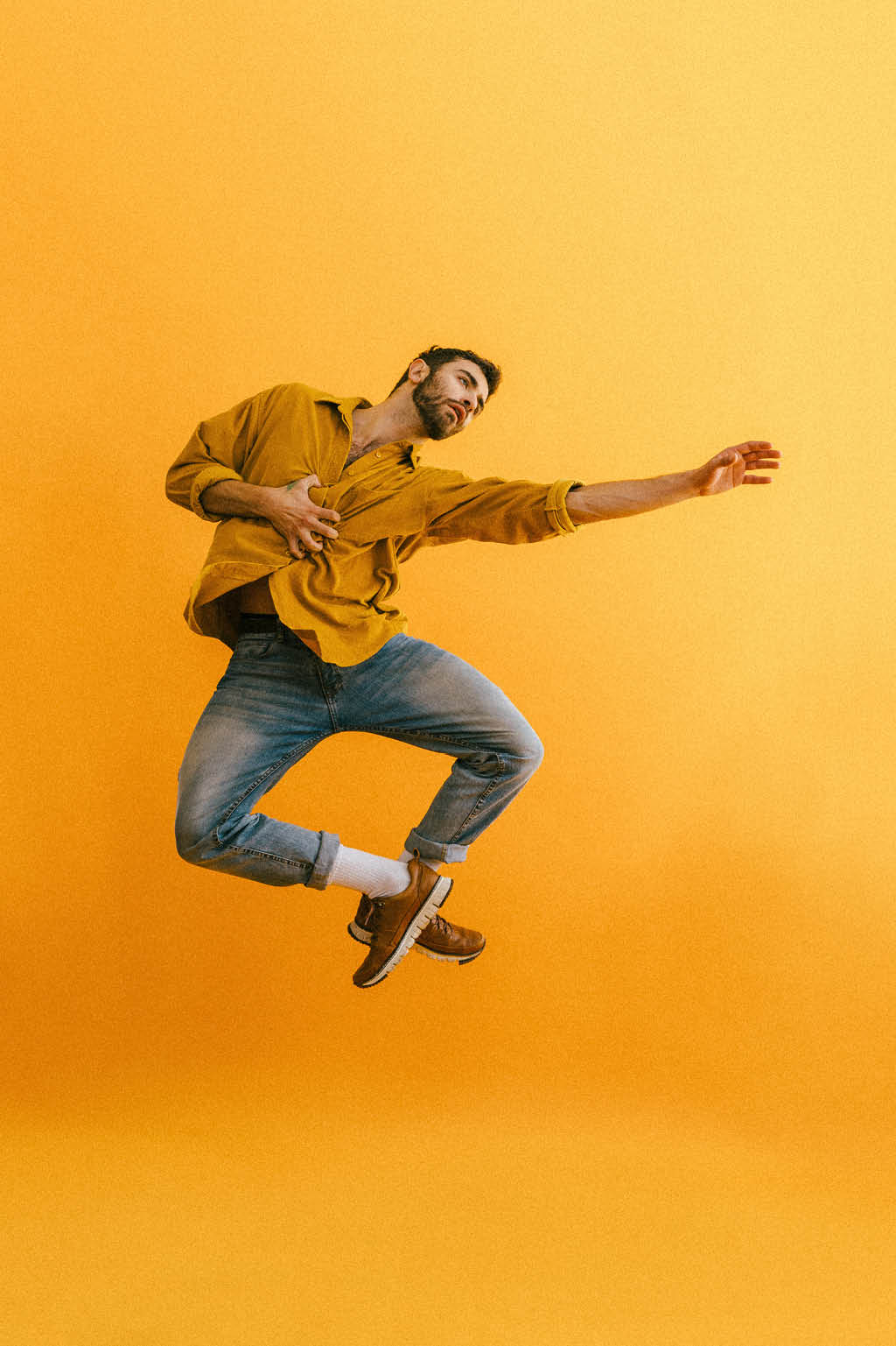 man dancing on yellow background