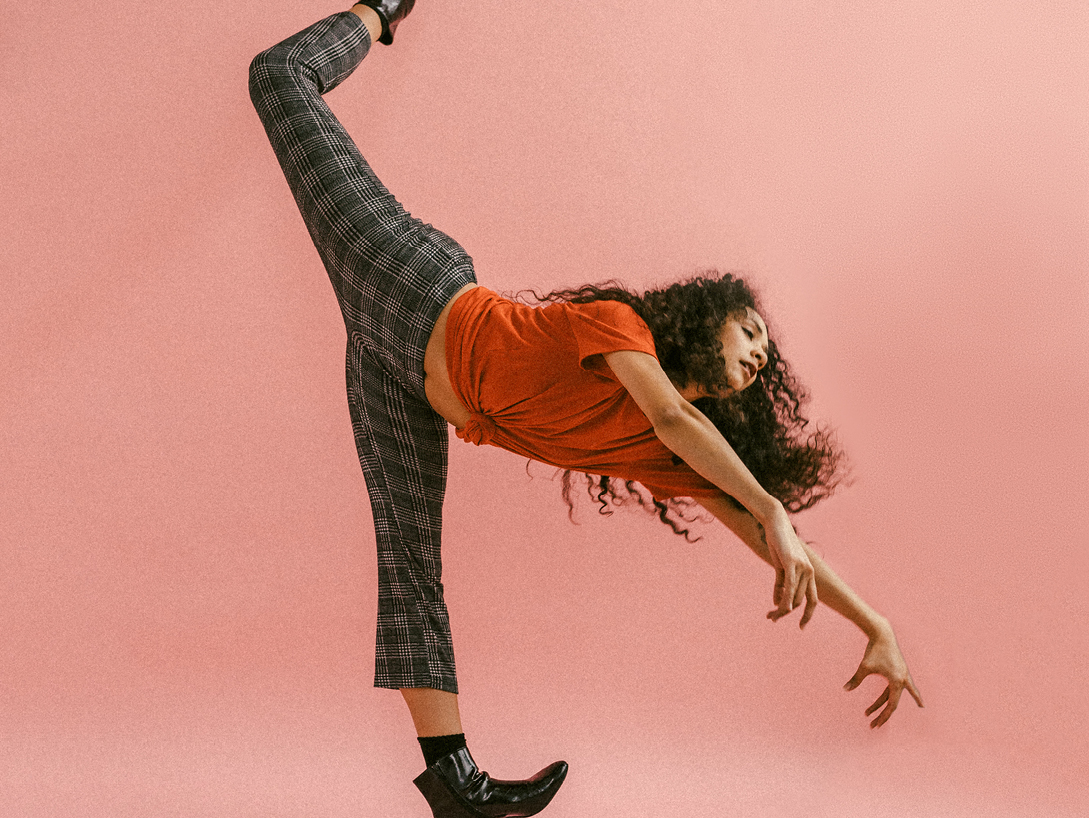 woman dancing on pink background