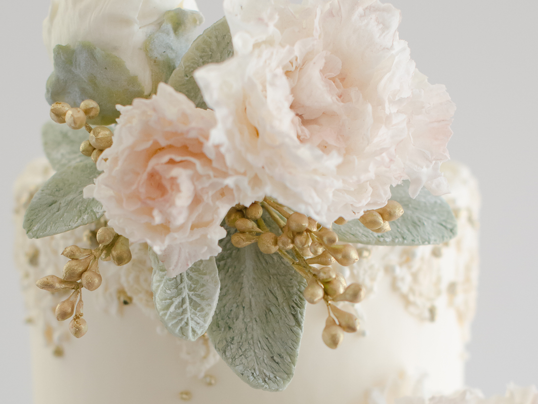 light pink cake flowers with green leaves