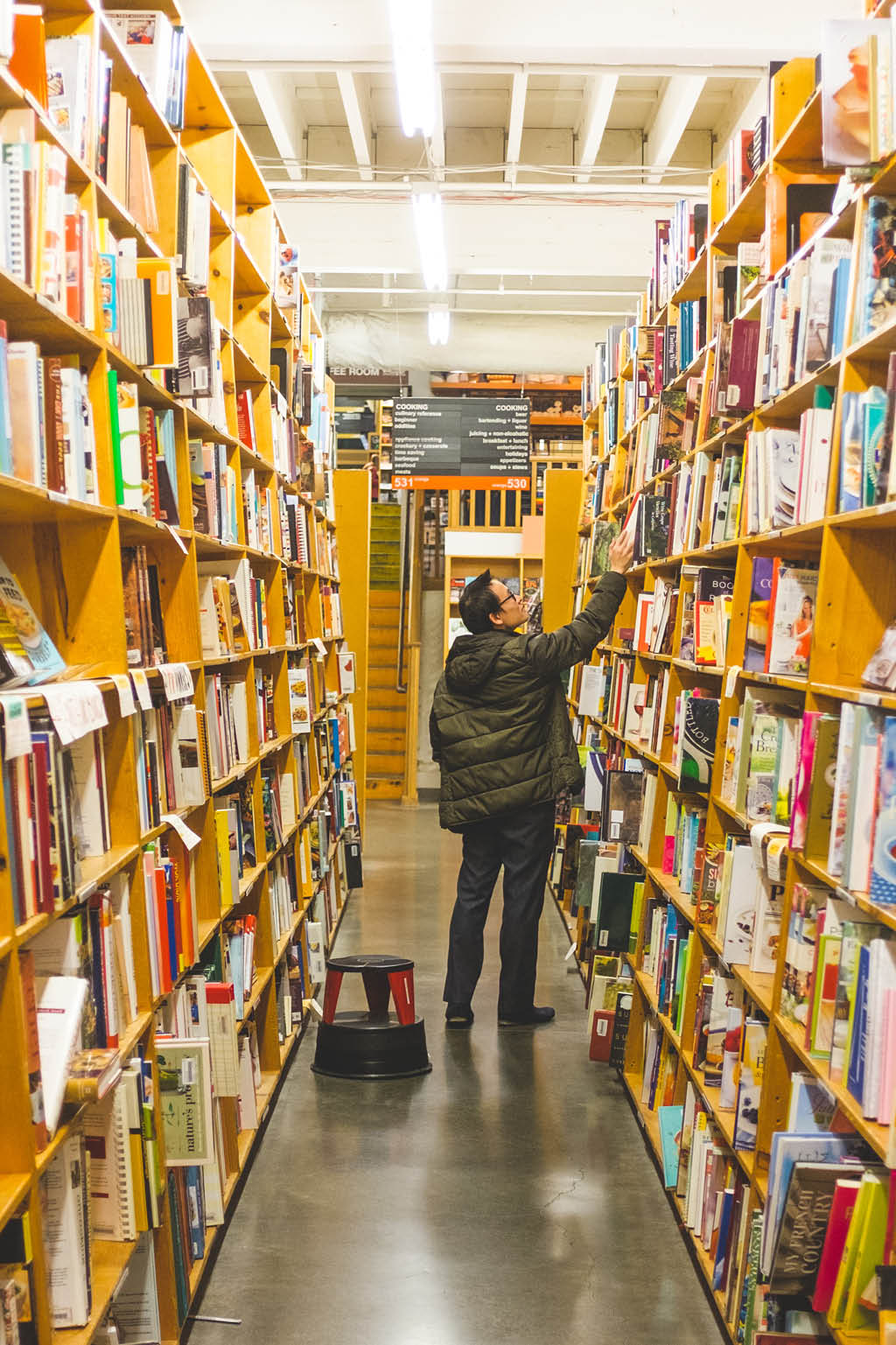 man browsing an aisle of books