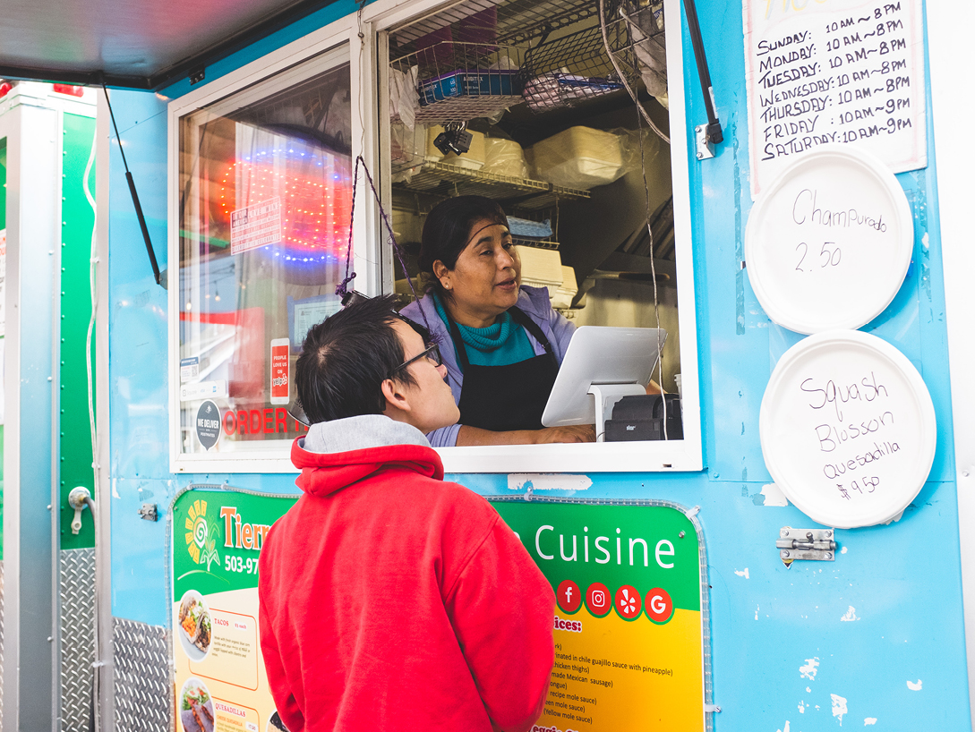 man ordering from a food truck