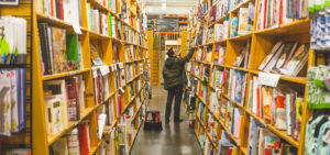 man browsing an aisle of books