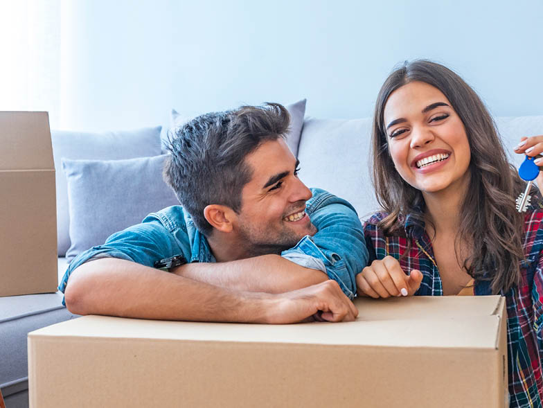young man and woman smiling at home