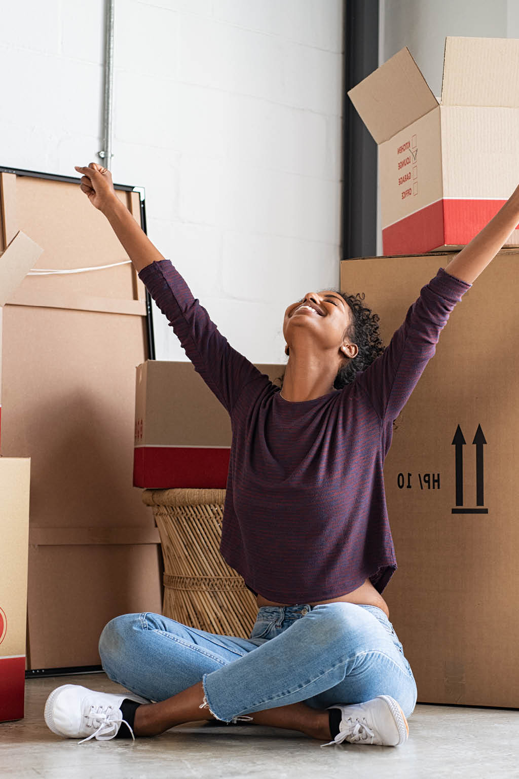 woman sitting around moving boxes