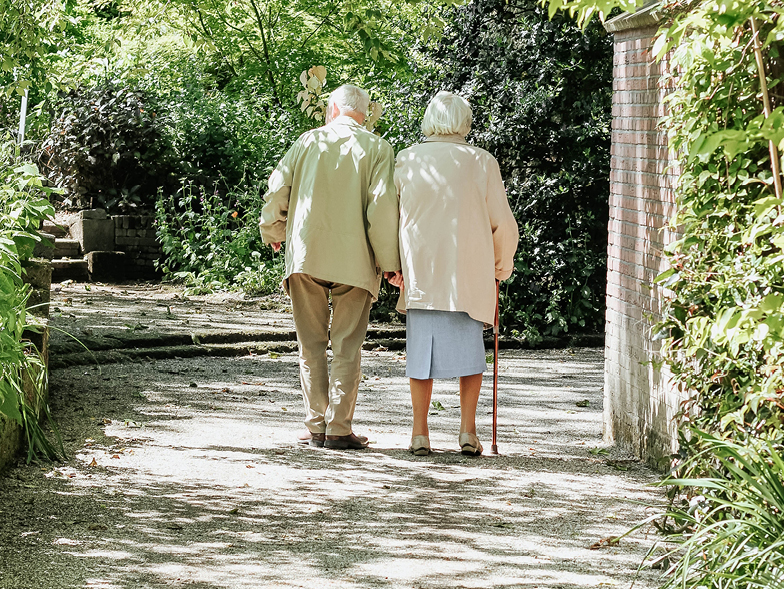 older couple walking along a path