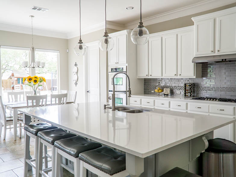all white kitchen with hanging light fixtures