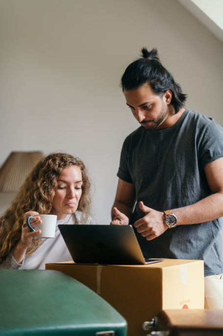 man and woman looking at a computer