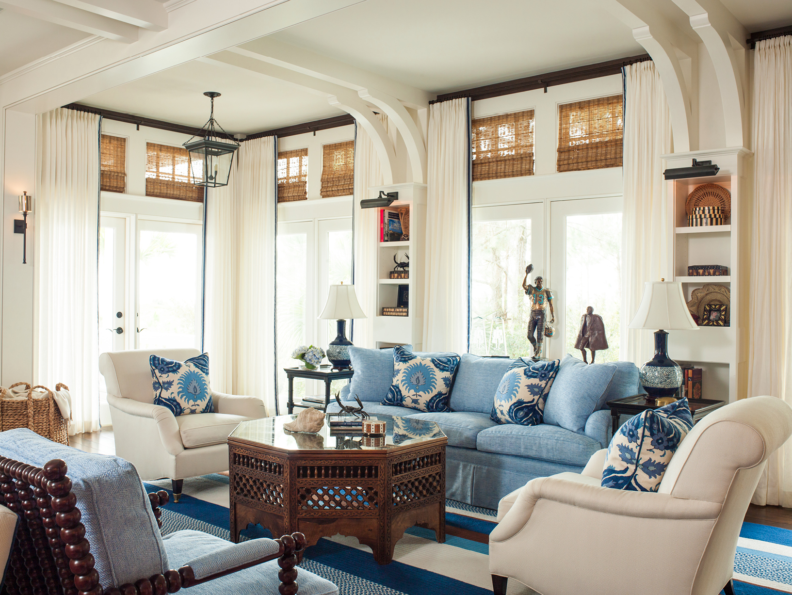 White and blue living room with blue sofa and wood coffee table