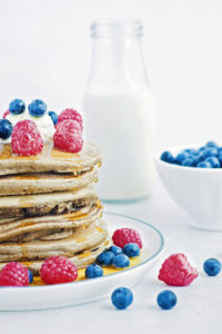 stack of buckwheat pancakes with fruit