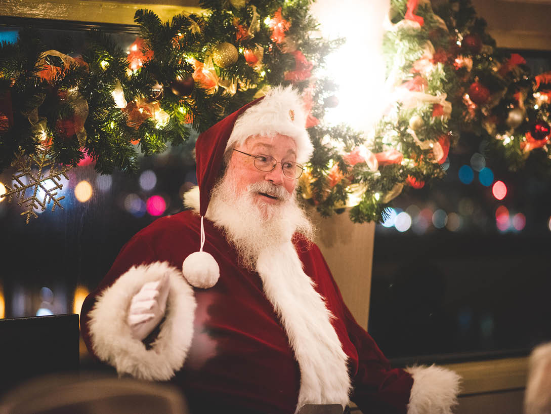 santa claus standing in front of tree