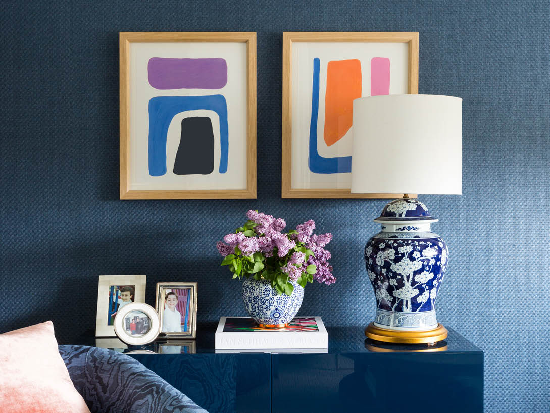 blue wall with art and white and blue lamp