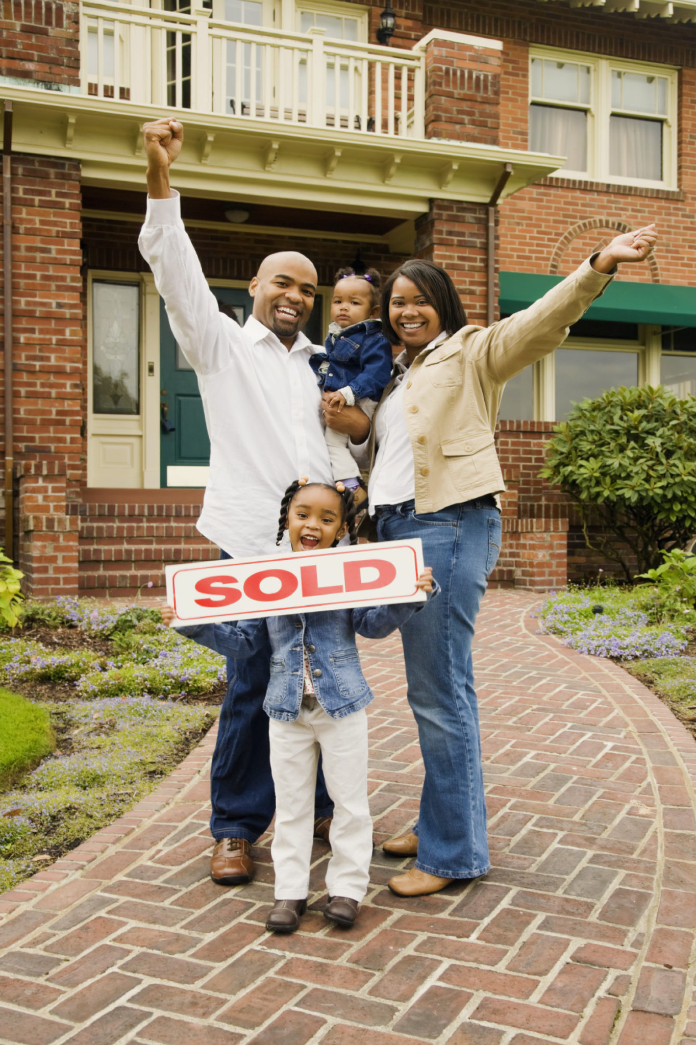 family holding a sold sign