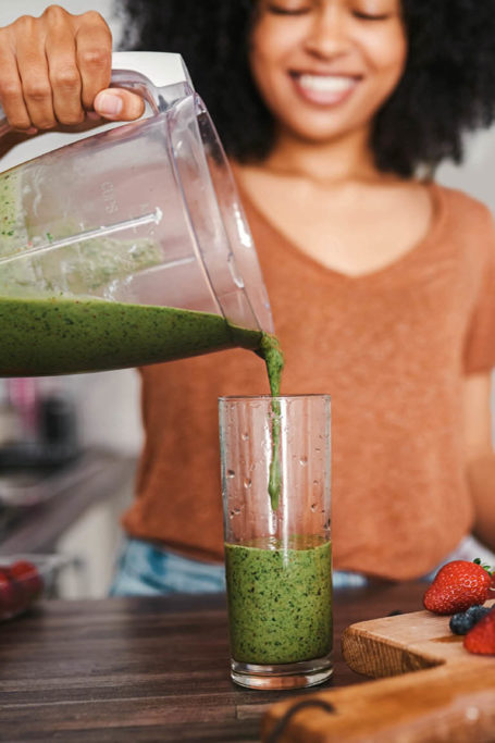 person making smoothie
