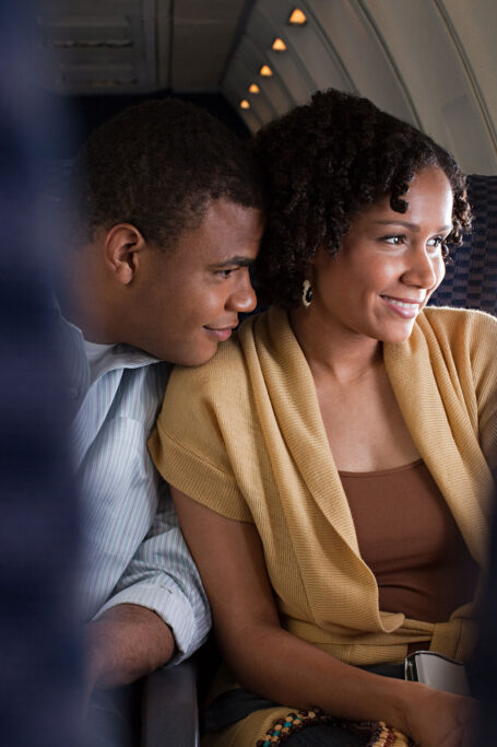 Couple looking out airplane window