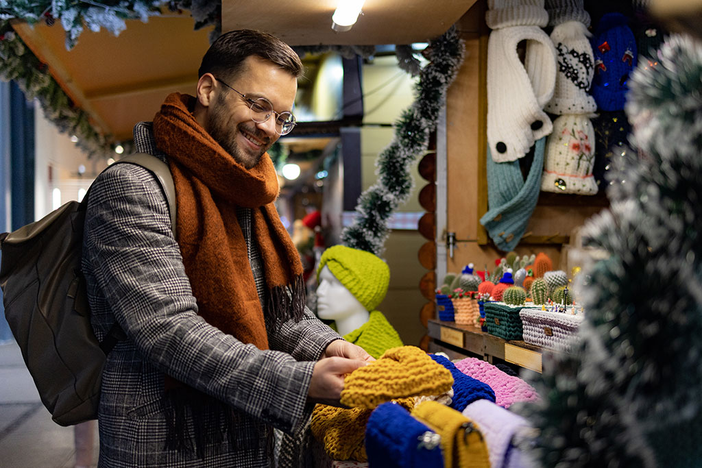 Man buying christmas scarf as gift