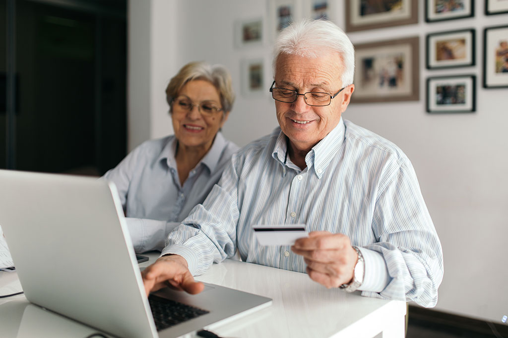 Lifestyle elderly couple the exercise of notebook computer, inserting in credit card number
