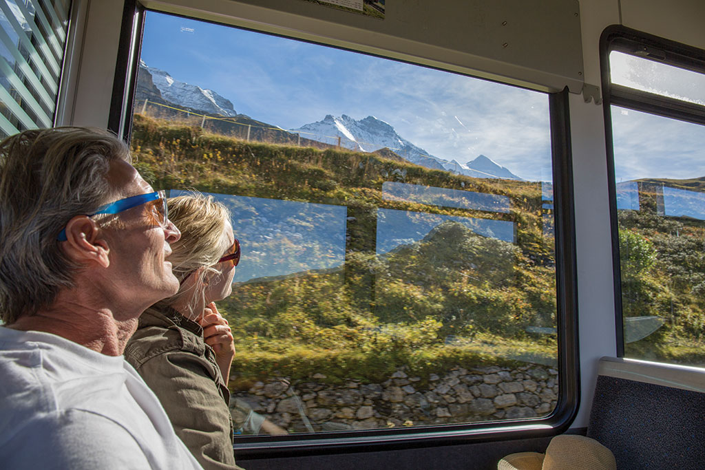 People looking out window of train