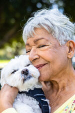 Older woman hugging dog