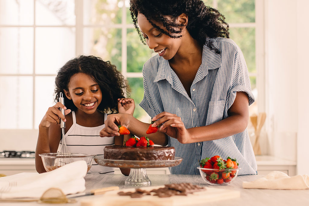 Mom and daughter making a cake