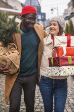 Couple walking down street with presents