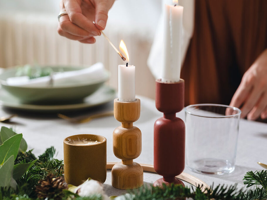 Woman hosting dinner and lighting candle