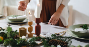 Woman hosting dinner and lighting candle